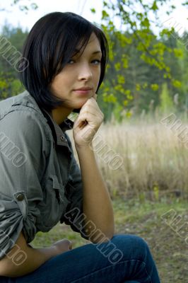 young sad woman in the forest