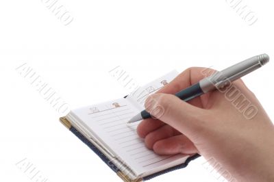 hand writes in a notebook