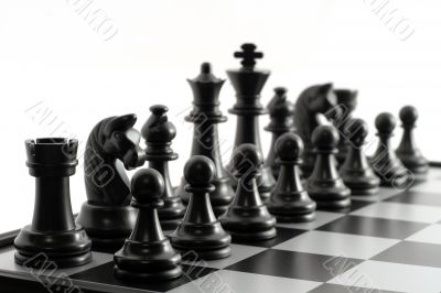 Black chessmen on a chessboard