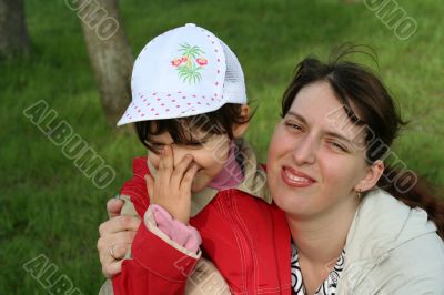 little girl with her mother in the spring park