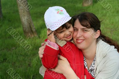 little girl with her mother in the spring park