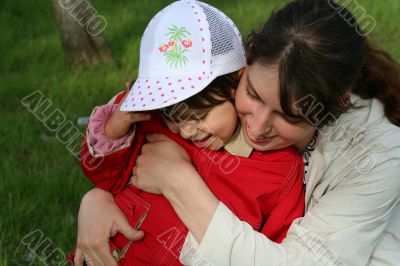 little girl with her mother in the spring park