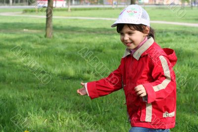little girl running in the spring park