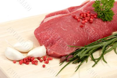 Steaks on a kitchen board