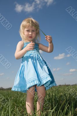little girl with grass in hands