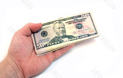 The hand stretching a pack of dollars