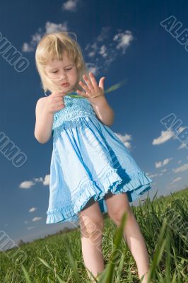 little girl with grass in hands