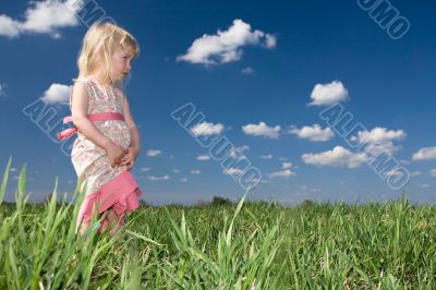 toddler girl on green meadow