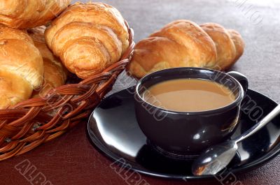 cup of coffee with fresh croissants