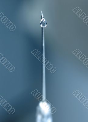 syringe close-up, focus on the drop