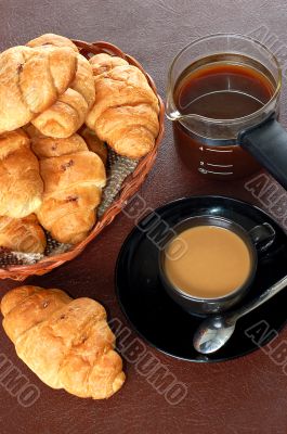 cup of coffee with fresh croissants