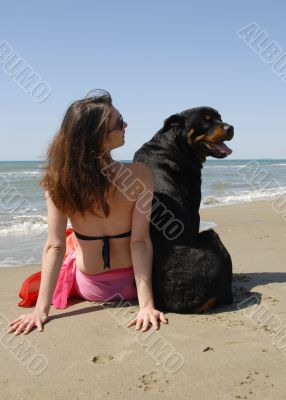 woman on the beach withe her rottweiler