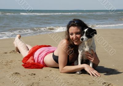 happy woman on the beach with her dog