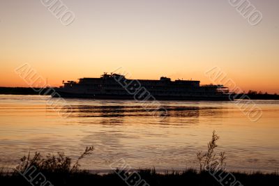 Evening on the river, the ship on sunset