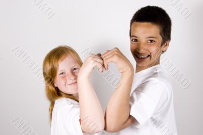 sibling making a heart together
