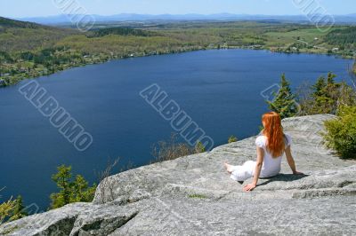 Young woman enjoying the view over lake