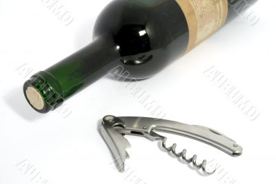 A bottle of white and a cork-screw