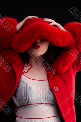 girl in red fur coat blowing kiss