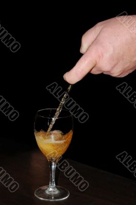 Waiter pouring white wine into glass