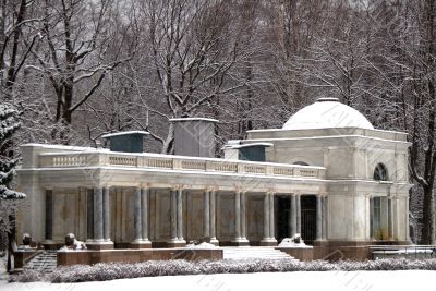 Winter in park. A classical building with columns.