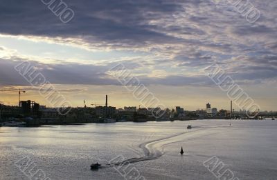 Sunset under city river