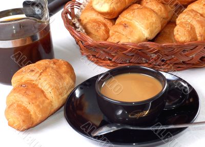 cup of coffee with fresh croissants