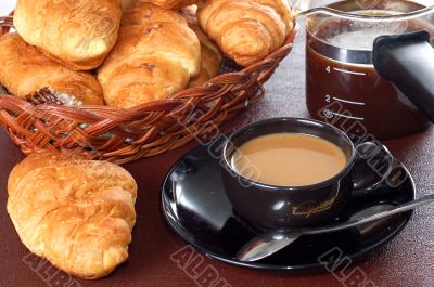 cup of coffee with fresh croissants