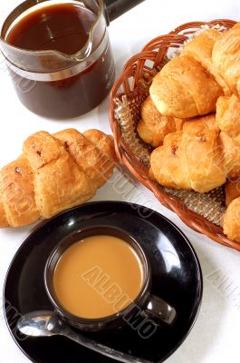 cup of coffee with fresh croissants