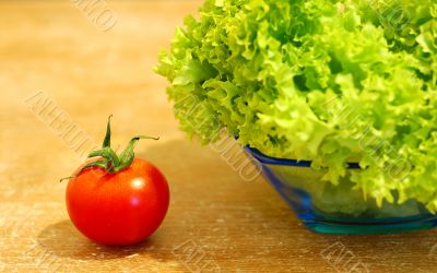 Fresh salad and a  tomato