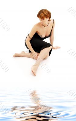 relaxed lady in black dress on white sand