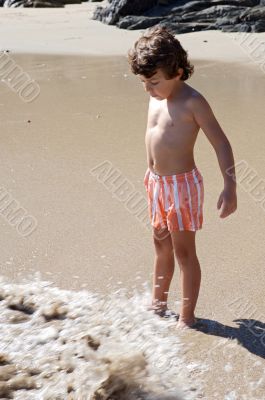 boy playing in the beach