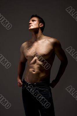 handsome topless man in jeans