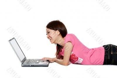 teenager working on her laptop happily