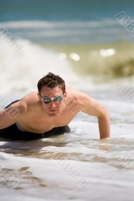guy getting up from the beach