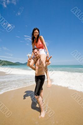 couple playful by the beach