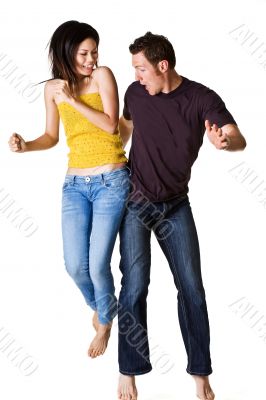 causasian guy and asian woman jumping excitedly