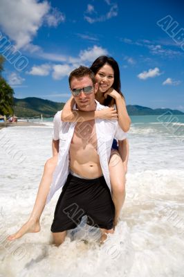 playful couple at the beach