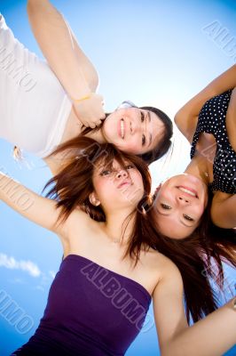 young girls gather around under the bright sunny sky