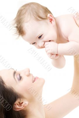 laughing blue-eyed baby playing with mom