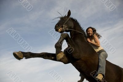 happy girl and rearing stallion