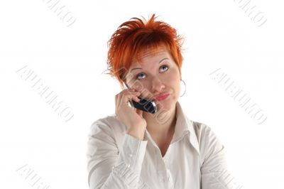 red haired woman talking by mobile phone unhappy