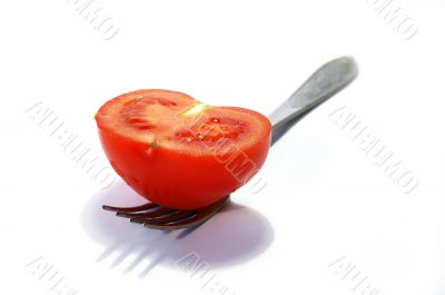 Fork and ripe tomato