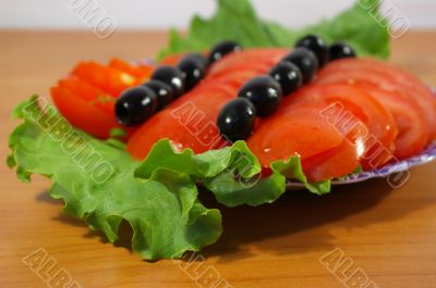 Tomatoes and leaves of salad