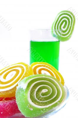 Multi-coloured fruit candy  and cold green drink