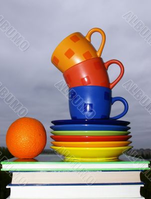 Cups, books and orange