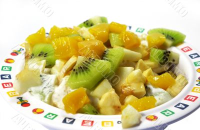 Fruit salad in a plate isolated on a white