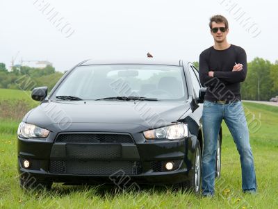 man near the black car