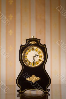 Vintage clocks on wallpaper background