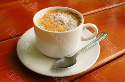 Cappuccino cup with metal spoon