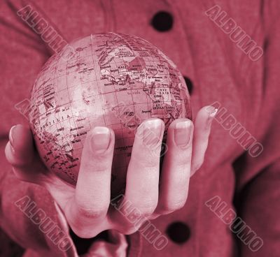 Globe in a girl`s hands